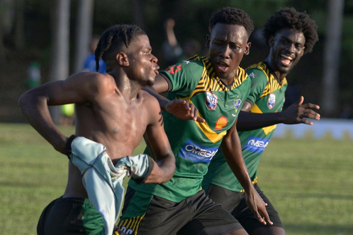 St. Benedict’s College’s Malachi Webb, left, takes of his shirt in celebration with team-mates Daniel Jones, centre, and Jaden Grant, after scoring the winner in their 3-2 victory over Naparima College at Lewis Street, San Fernando on Wednesday, October 4th 2023. PHOTO BY: Dexter Philip