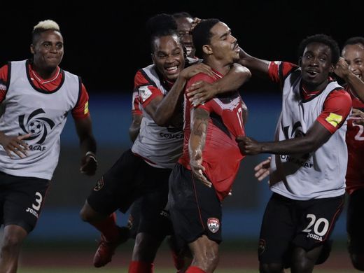 Photo: Trinidad and Tobago right-back Alvin Jones (third from left) celebrates with teammates after his stunning goal against the United States during 2018 World Cup qualifying action in Couva on 10 October 2017. (Copyright AFP 2017/Luis Acosta)