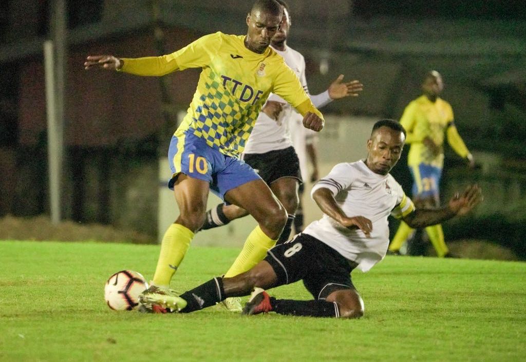 Central FC skipper Kevon Goddard (R) tackles Defence Force's Hashim Arcia during the TT Pro League match, at the Phase II Recreational Facility,La Horquetta, on Tuesday.