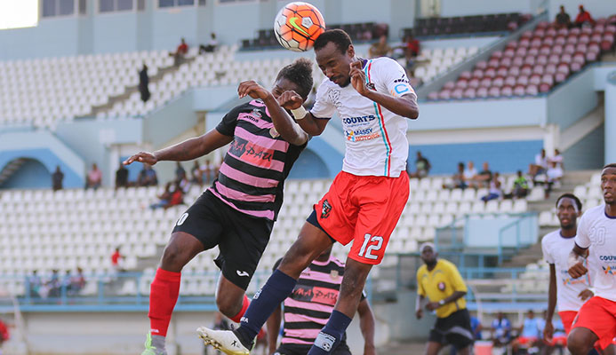 Morvant Caledonia United veteran full-back Kareem Joseph, right, vies for the ball with a North East Stars player during the 2016/17 Pro League season.