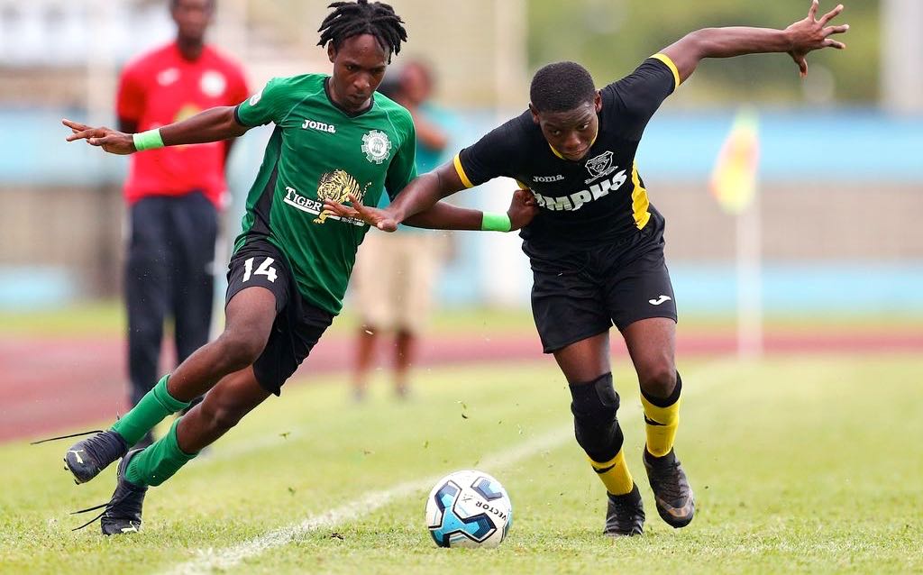 Carapichaima East Secondary attacker Josiah Hypolite, left, jostles with Miracle Ministries High’s Daniel Hope for possession during the Secondary School Football League’s Central Zone Intercol match at the Ato Boldon Stadium in Balmain, Couva, yesterday. Carapichaima won 6-1. (Photo by Daniel Prentice)