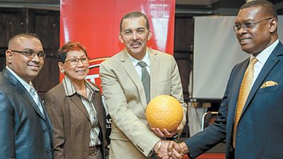 President Anthony Carmona, second from right, shakes hands with T&T Football Association president Raymond Tim Kee during the launch of the TTFA Youth Football Clinics and distribution 15,000 virtually indestructible footballs for primary schools across the country. With them are Lifestyle Motors senior manager Marlon Garib and the projectÂ’s coordinator Mary Siu Butt. Photo courtesy TTFA media
