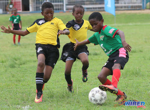 Photo: San Juan Jabloteh’s Raheem Mohan (right) tries to elude two Cunupia Extreme players during RBNYL Under-11 action at Constantine Park in Macoya on 10 June 2017. Jabloteh won 2-0. (Courtesy Sean Morrison/Wired868)