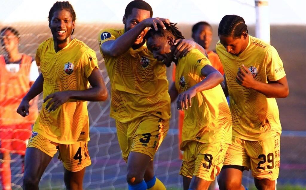 AC Port of Spain's Kadeem Corbin (9) is congratulated by teammates after scoring against 1976 Phoenix FC during the TT Premier Football League match, on Friday, at the Dwight Yorke Stadium, Bacolet. - Photo courtesy TT Premier Football League
