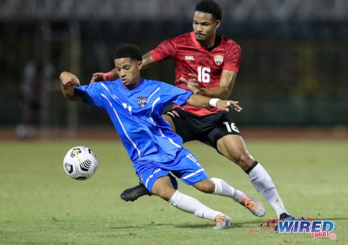 Teenaged Saint Martin winger Kaïlé Auvray (left) takes on Trinidad and Tobago right back Alvin Jones during friendly action at the Hasely Crawford Stadium on 29 January 2023. (Copyright Daniel Prentice/ Wired868)