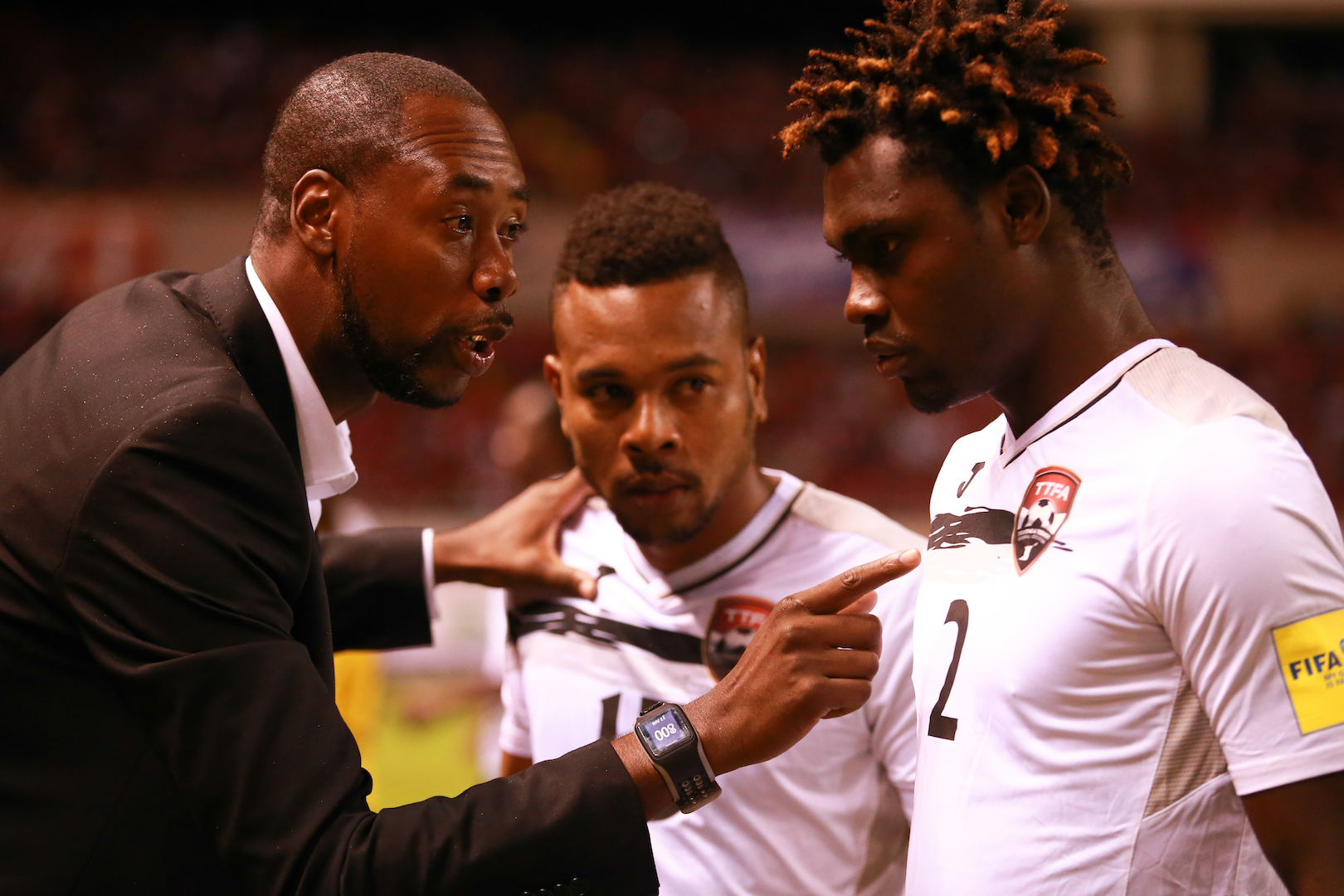 Headcoach Dennis Lawrence gives final instructions to defenders Aubery David (#2) and Curtis Gonzales ahead of the start of the FIFA Russia 2018 World Cup Qualifier match vs Costa Rica. Photo by Allan Crane (For editorial use, please contact Allan Crane)