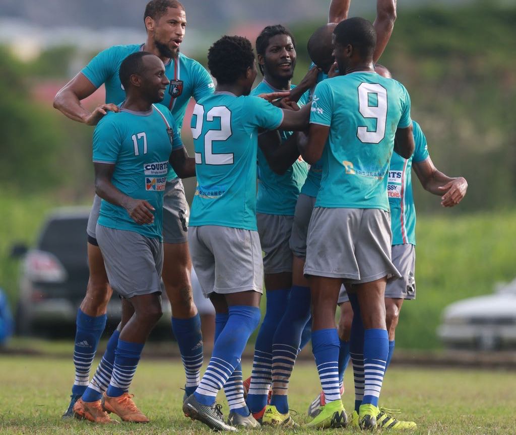 Morvant Caledonia AIA players celebrate a goal during the Ascension Invitational match against Club Sando at the Mannie Ramjohn Stadium in Marabella on Sunday.