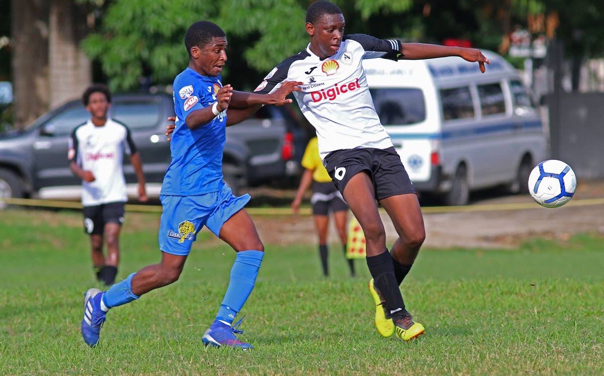 These secondary school footballers, who represent Naparima College (blue) and St Agustine (white), vie for the ball in their SSFL match,at Lewis St, San Fernando,yesterday.