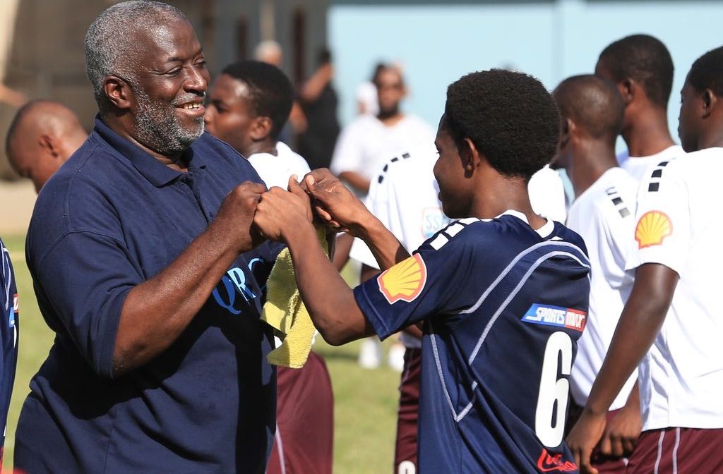 WELL DONE Coach Nigel Grosvenor shows his appreciation for the effort of one of his players during Round 1 of the 2019 SSFL match between QRC and East Mucurapo Secondary at QRC Grounds, St. Clair. The match ended 2-2.  Allan V. Crane
