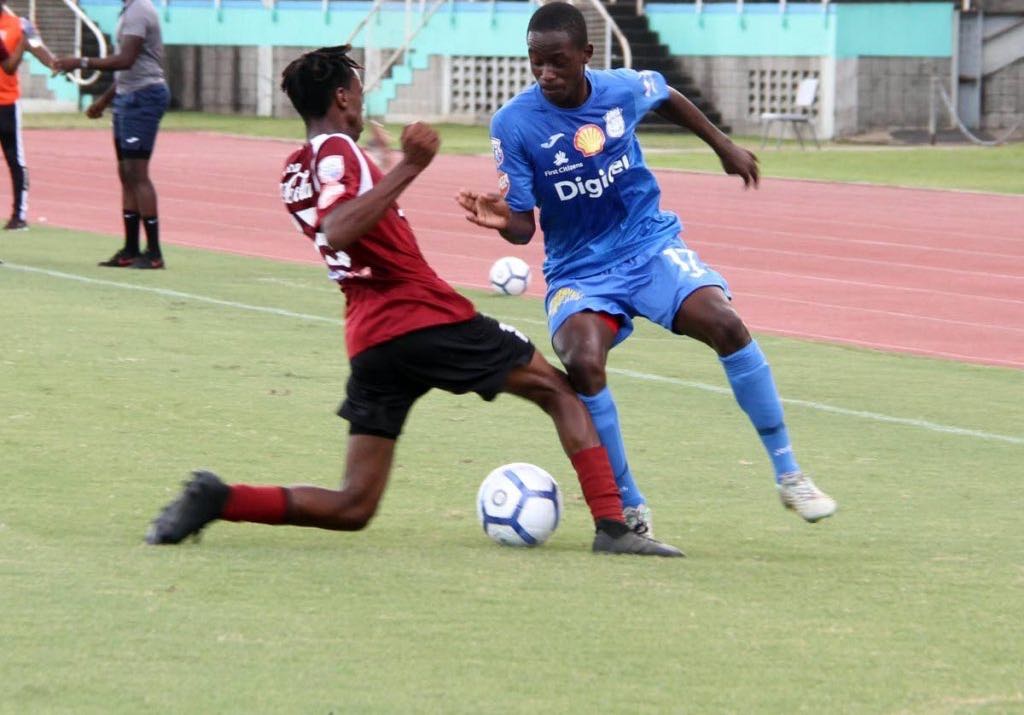 Matthew Hezron of Pleasantville Secondary,left, and Naparima College's Nathaniel Perouse battle for the ball during the SSFL match held at Mannie Ramjohn Stadium, Marabella,yesterday.
