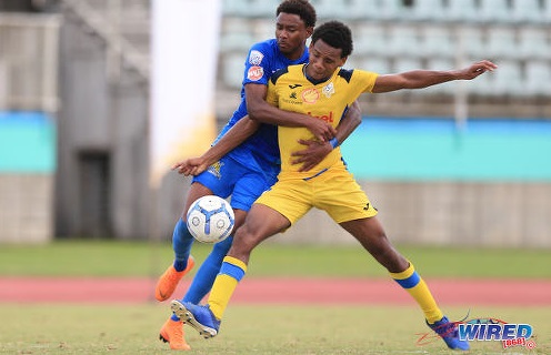 Photo: Presentation (San F’do) defender Nigel Caraby (right) tries to hold off Naparima attacker Seon Shippley during SSFL action in Marabella on 23 October 2019. (Copyright Allan V Crane/CA-Images/Wired868)