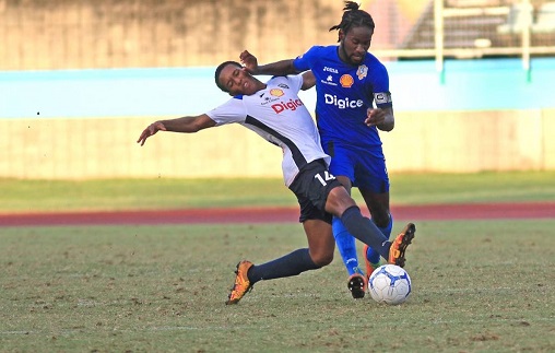 Presentation College’s Barclay Aleem (R) vies for control of the ball with Queen’s Royal College’s Miguel Cross (L),yesterday,during the Secondary Schools Football League match,at the Manny Ramjohn Stadium,Marabella. - MARVIN HAMILTON