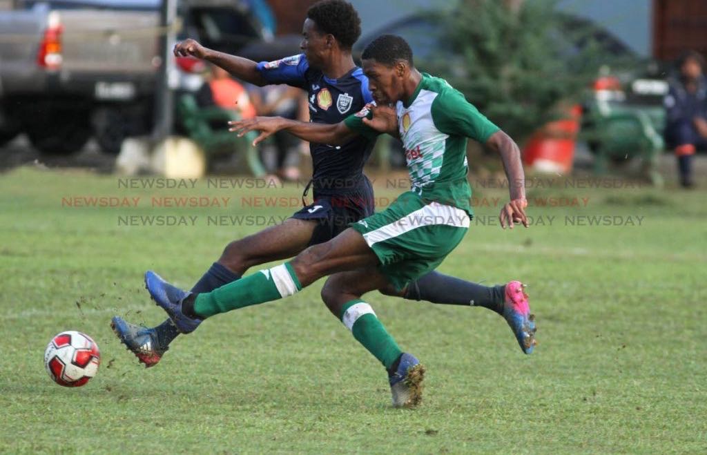 Renaldo Mullings (L) of Queen's Royal College and Tyrese Spicer of St Augustine Secondary School vie for the ball during the Secondary Schools Football League match, at the QRC Grounds, Port of Spain, yesterday.