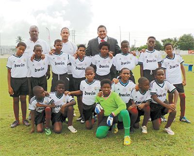 Minister of Sport and Youth Affairs Darryl Smith, back right, poses with the San Fernando Boys team.
