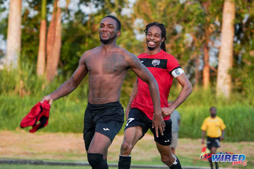 Photo: San F’do Giants midfielder Yohannes Richardson (left) celebrates his decisive penalty kick with captain Odell Fitzallen during Ascension action against Deportivo PF at the Mannie Ramjohn Stadium Training Field on 29 September 2019. (Copyright Daniel Prentice/CA-Images/Wired868)