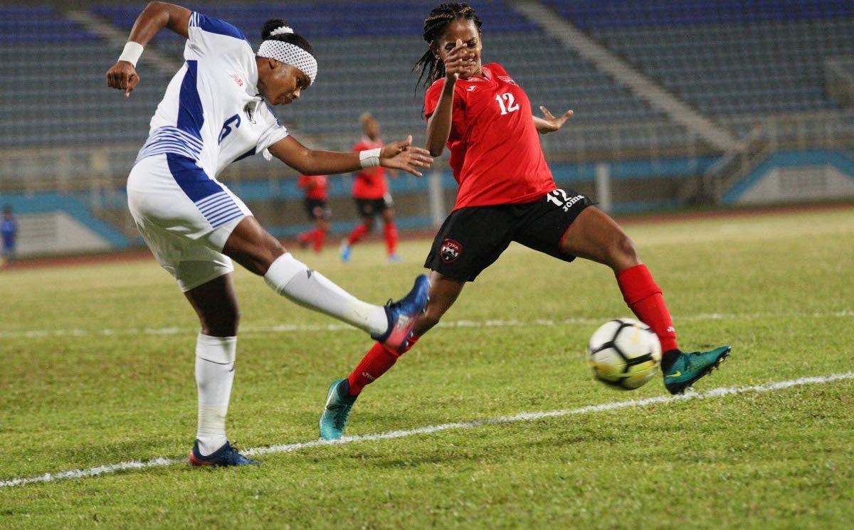 T&T’s Shanelle Arjoon,right, defends a shot from Kenia Rangel, of Panama, on Thursday during a international friendly held at the Ato Boldon Stadium, Couva.