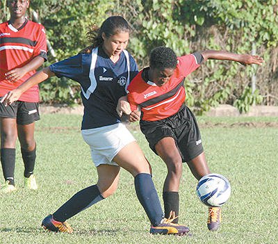 Kimberlee Woo Ling, right, of St Joseph Convent (PoS) challenges Arissa Romany of Bishop’s Anstey (PoS) in their North Zone BGTT/First Citizens Secondary Schools Football League Girls Championship Division match at St Joseph Convent Ground, Federation Park, St Clair, on Sunday. Bishop's Anstey won 1-0. Photo: Anthony Harris