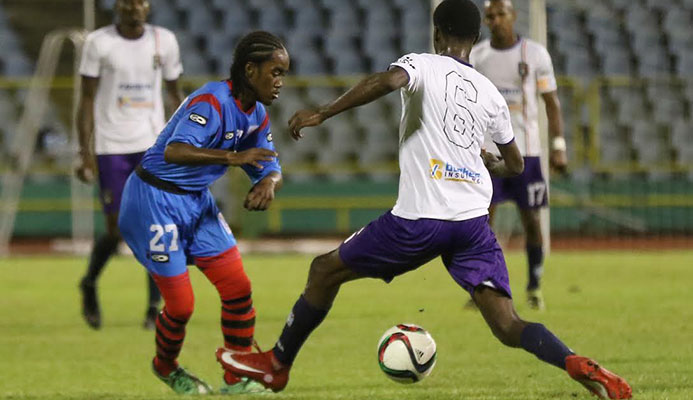 ​Photo: St. Ann’s Rangers attacker Che Benny, left, and Morvant Caledonia United’s Taje Commissiong vie for the ball during the 2016-17 Pro League season.