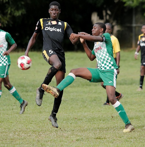 St Augustine player Jamal Ollivere, right, vies for the ball with Trinity College Moka's Jahiem Marshall during the Secondary School Football League Premiership Division at St Augustine School Grounds on October 22. Trinity Moka won 3-1. ...ABRAHAM DIAZ