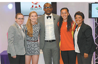 Minister of Sport Brent Sancho, centre, is flanked by Women's Premier League coaches, Joanne Daniel, far left, and Carla Aleman, far right, both of whom lead the franchise, Dragons, along with the team's drafted players, Isabella Hayes of the UK, left, and T&T woman player of the year, Arin King, right, at the draft for the Women's Premier League, at the Hasely Crawford Stadium, Mucurapo, yesterday. Photo: Anthony Harris.