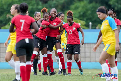 Photo: Trinidad and Tobago goal scorer Nia Walcott (centre) is congratulated by teammates during Olympic qualifying action against Aruba in Couva on 30 September 2019.