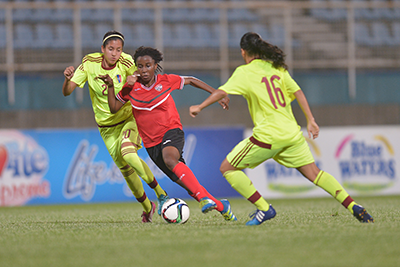 T&T's Ranae Ward,centre, blows past two defenders during the Women's International friendly between T&T and Venezuela at the Ato Boldon Stadium in Couvaon Wednesday. 