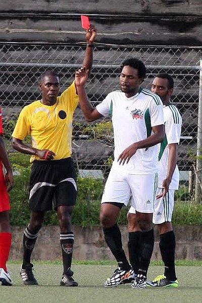 Club Sando defender Devon Drayton walks away from the referee after being dismissed for dissent during a TTFA National Super League encounter against Joe Public at the Marvin Lee Stadium, Macoya on Sunday. Club Sando won the match 2-1. Photo: Anthony Harris.