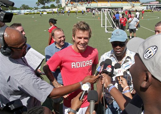 David Beckham, former England's soccer team captain and Los Angeles Galaxy midfielder, center, speaks with reporters accompanied by Jack Warner, the vice-president of the International Federation of Football Association, FIFA, second right, during a coaching clinic in Macoya, Trinidad and Tobago, Sunday, Sept. 26, 2010. Beckham is visiting Trinidad and Tobago to bolster both England's World Cup bid and Caribbean youth football. (AP Photo/Anthony Harris) (AP Photo/Shirley Bahadur) TRINIDAD AND TOBAGO OUT