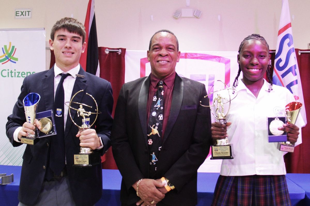 SSFL president Merere Gonzales, centre, with the “Players of the Year” for SSFL 2023, with their trophies, Michael Chaves of Fatima College, left, and J’Eleisha Alexander of Scarborough Secondary at the awards and prize giving distribution held at the Chamber of Commerce Building, Couva on Thursday, April 18th 2024. PHOTO BY: Vashti Singh