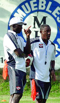 Assistant coach Dwight Yorke & Russell Latapy facing axe.