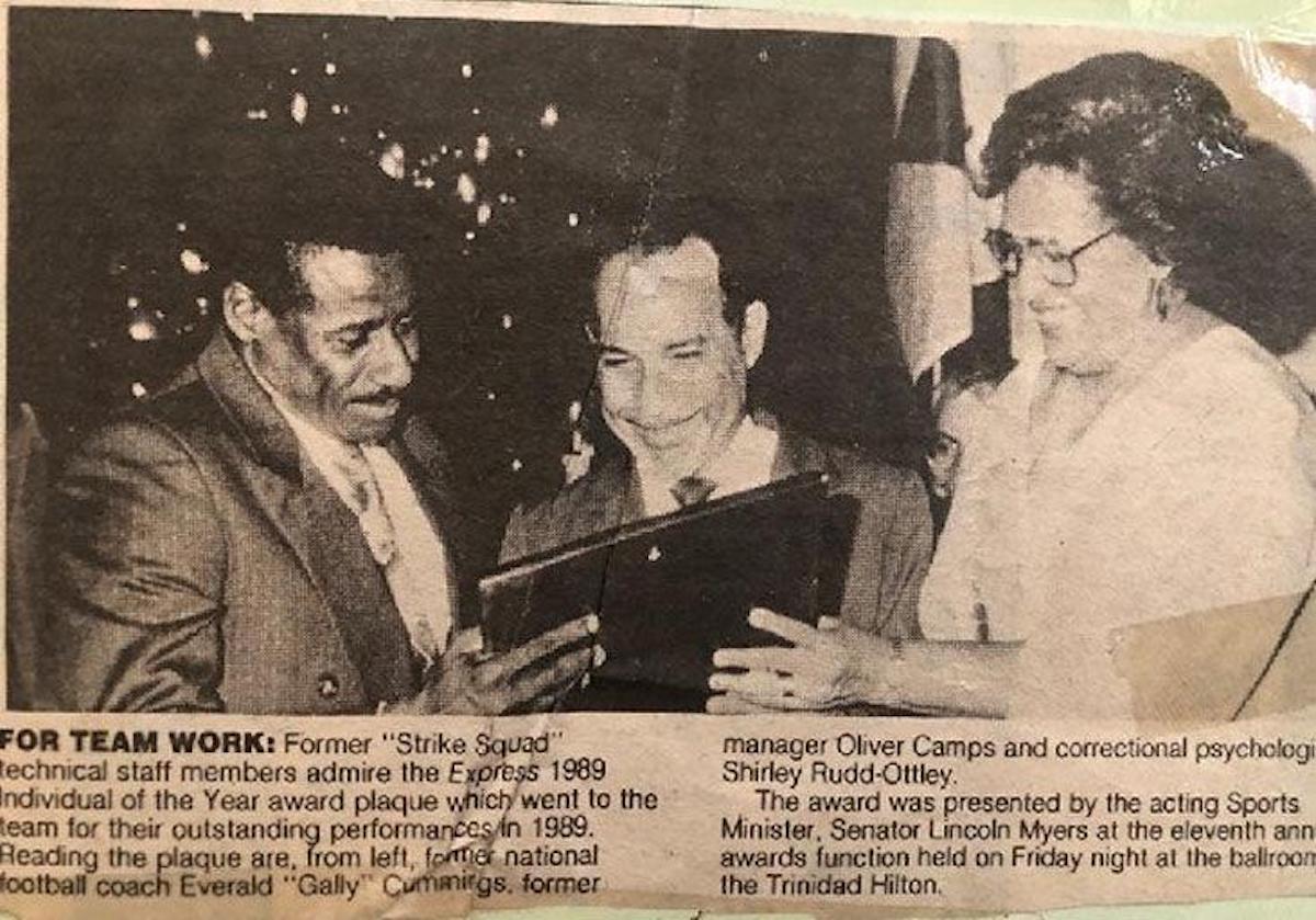 FLASHBACK: From left, Strike Squad coach Everald “Gally” Cummings, manager Oliver Camps, centre, and team psychologist Shirley Rudd-Ottley admire the Express Individual of The Year award given to the team in 1989 for its effort in that year’s World Cup qualifying campaign.