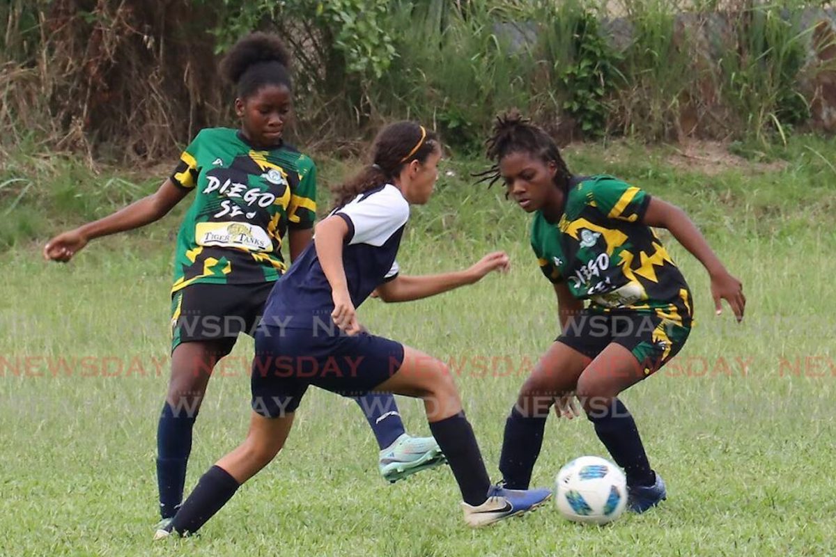 Katelyn Darwent of St Joseph's Convent dribbles Diego Martin Central's Naima Julius and Faith Williams during a SSFL game at Diego Martin Central ground, Thursday September 28th 2023. PHOTO: Roger Jacob
