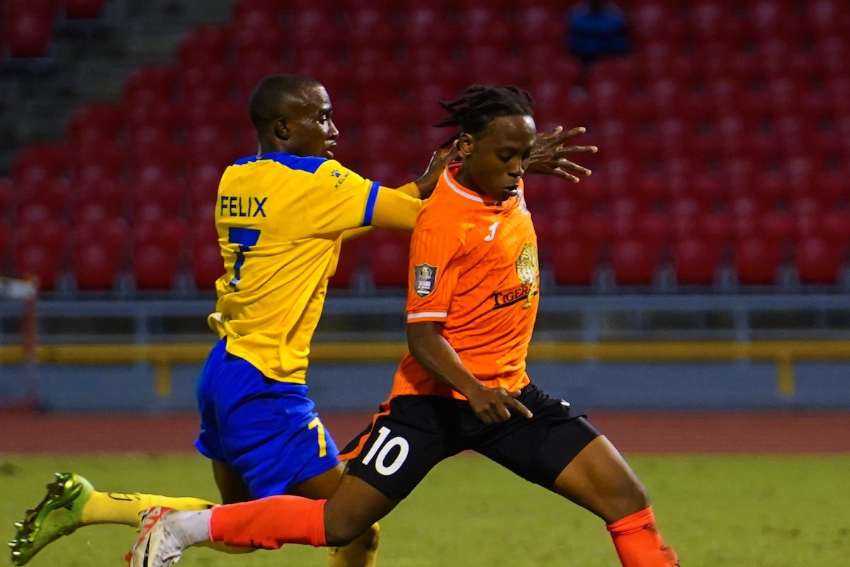 Defence Force's Jelani Felix (left) challenges Club Sando's Real Gill (right) for the ball during a TTPFL match at Hasely Crawford, Port of Spain on Friday, December 15th 2023.