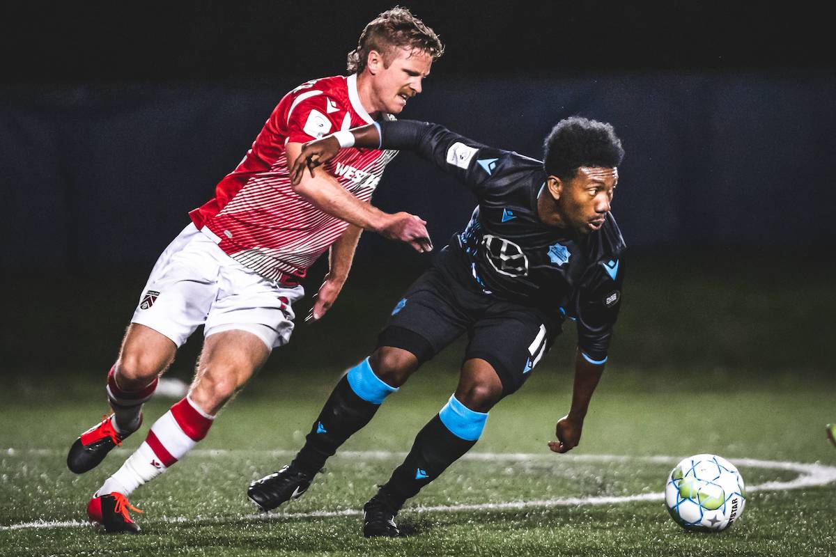 HFX Wanderers striker Akeem Garcia (right) breaks away from a Cavalry FC defender during a 2020 Canadian Premier League match at the Island Games in Charlottetown, Prince Edward Island
