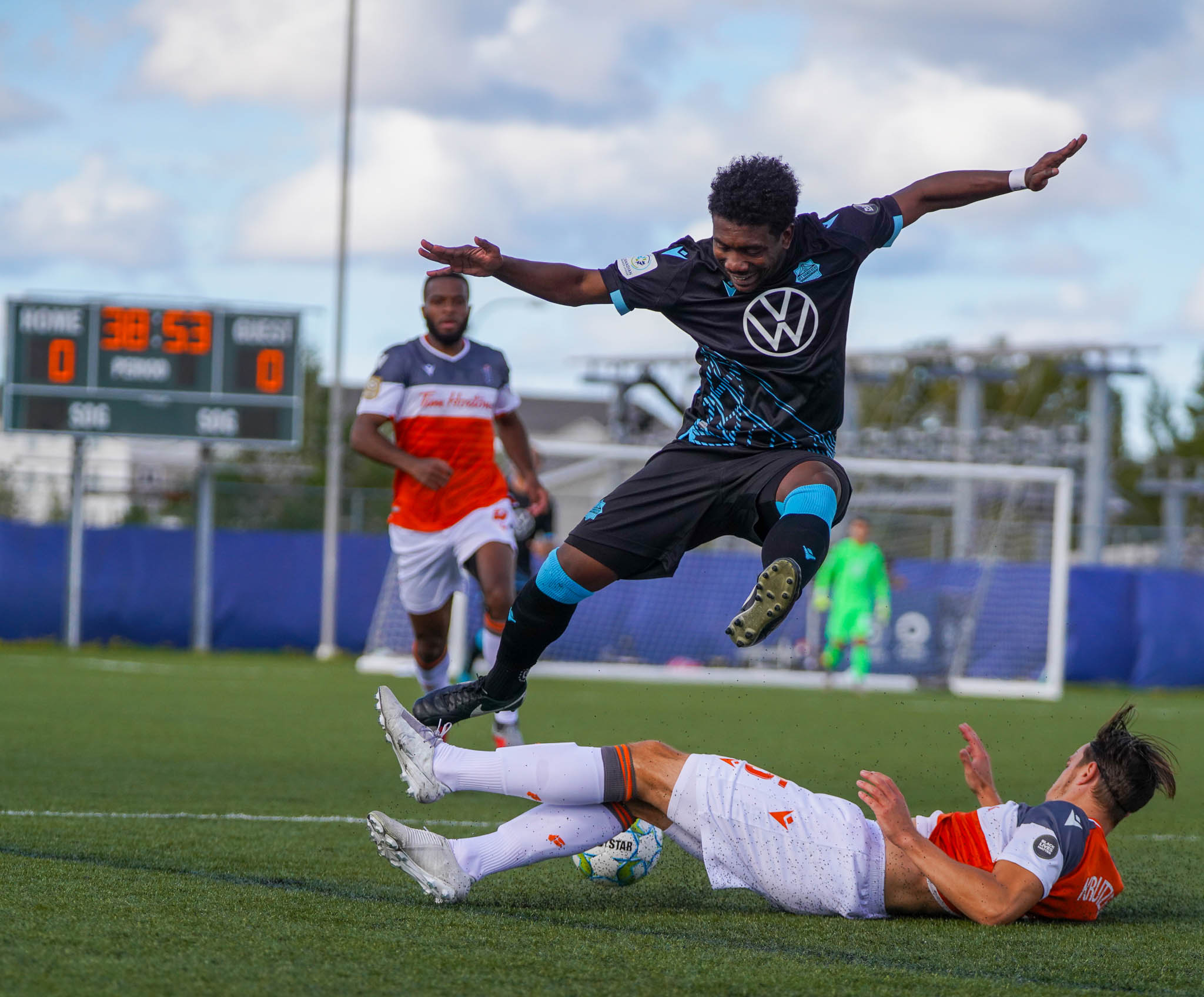 HFX Wanderers attacker Akeem Garcia evades a tackle from Forge FC's Daniel Krutzen. (CPL/Chant Photography)