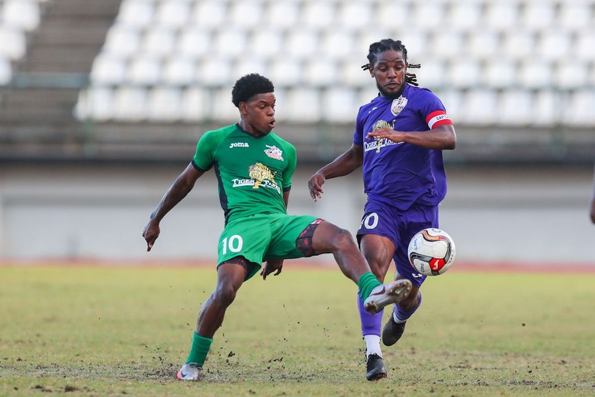 Club Sando debutant striker Nathaniel James, left, vies for possession with AC Port of Spain’s talisman Duane Muckette during the T&T Premier Football League at the Larry Gomes Stadium in Malabar, Arima on March 19th 2023. James scored the lone goal in Club Sando’s 1-0 win.