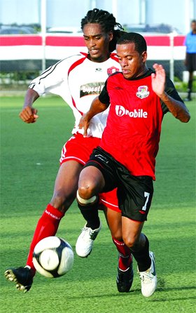 Joe Public's Hayden Tinto, right, heads for goal under pressure from Ma Pau's Keeron Benito in their Digicel Pro League match at the Marvin Lee Stadium, Macoya, yesterday. ..Photo: Anthony Harris