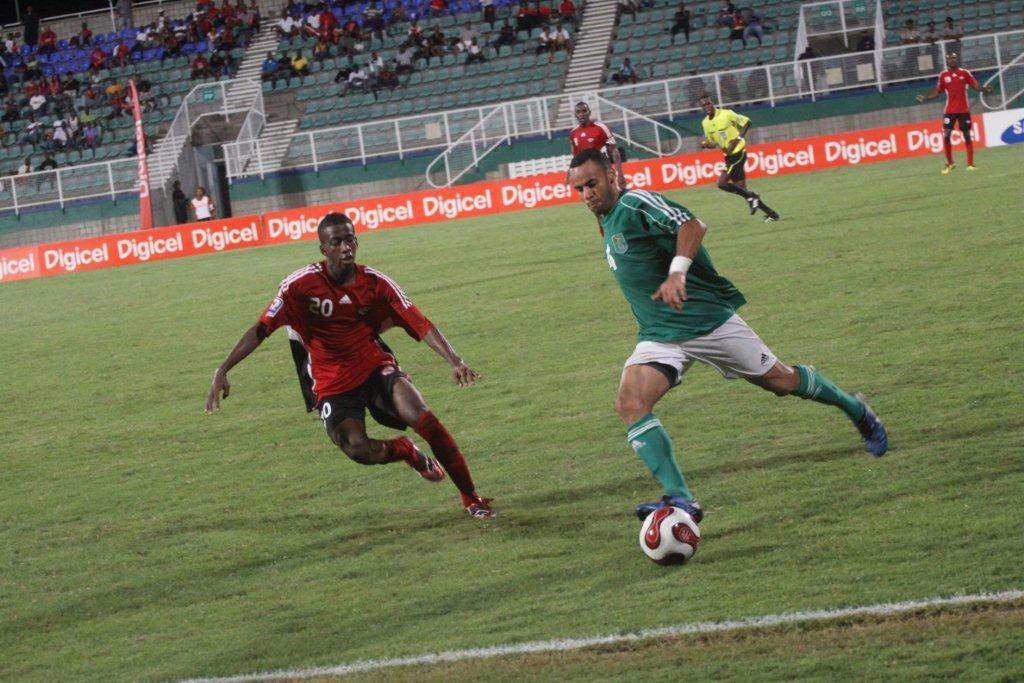 Kevin Molino (left) vs Guyana.
