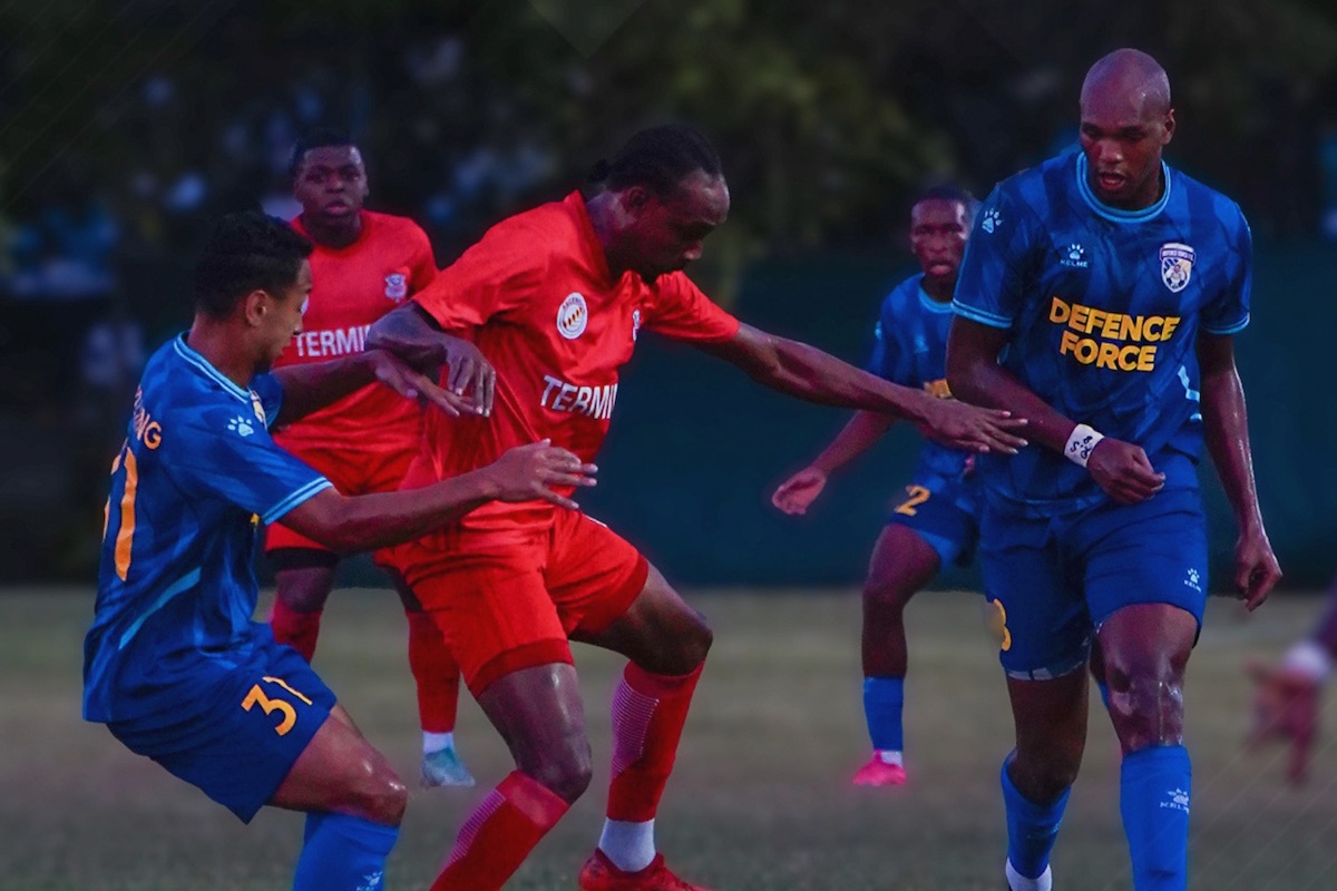 La Horquetta Rangers' Tyrone Charles (middle) fends of a challenge from Defence Force's Matthew Woo Ling (left) while Brent Sam (right) looks on during a TTPFL match at La Horquetta Recreation Ground on Saturday, April 6th 2024.