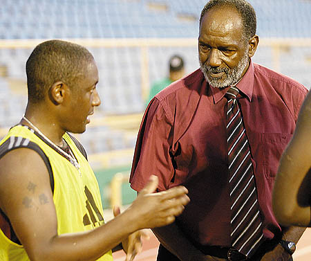 Lincoln Phillips chatting with former T&T head coach Russell Latapy.