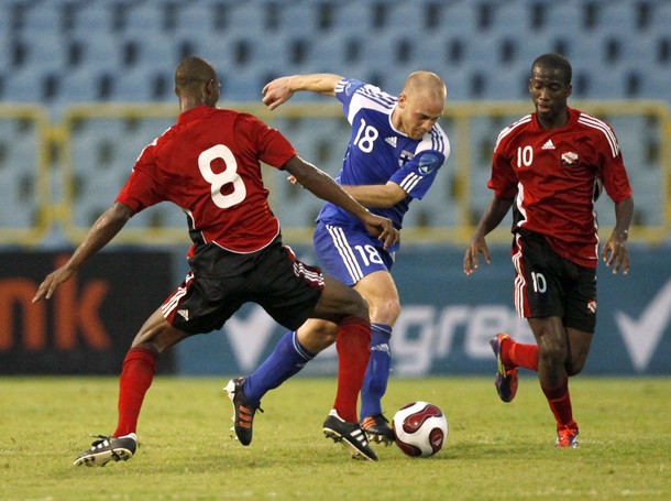 Daniel Sjolund of Finland being double team by T&T's #8 Guerra and #10 Molino