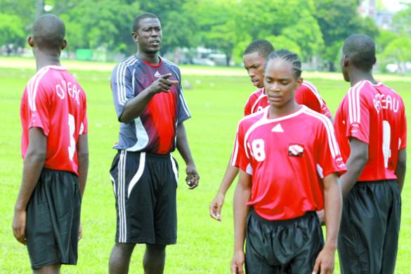 T&T Under-17 footballers interim coach Ross Russell has the attention of some of his players during a training session at the Queen’s Park Savannah, St Clair, yesterday in preparation for today’s match against St Kitts/Nevisin Group E of the Caribbean Football Union Second Round qualifiers at the Marvin Lee Stadium, Macoya from 11am. Photo: Anthony Harris
