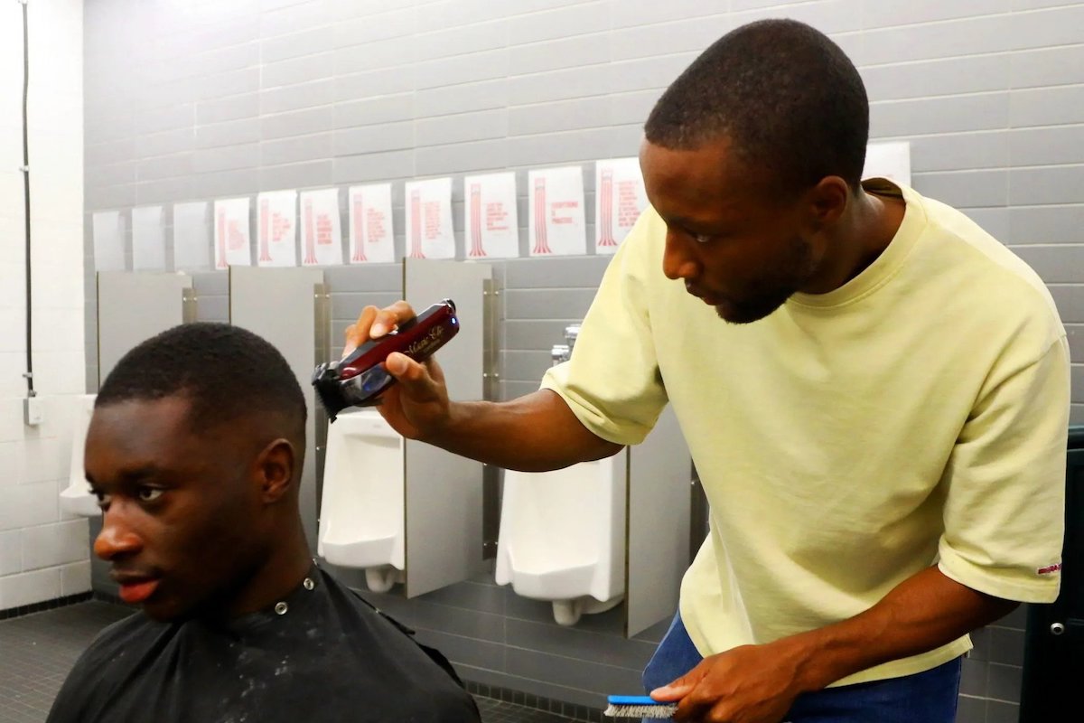 Atletico Ottawa's Malcolm Shaw cuts the hair of his teammate Aboubakary Sacko. PHOTO BY JEAN LEVAC /Postmedia