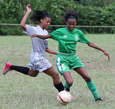 Otisha David from St Augustine tries to evade a challenge from San Juan North player Victoria De Silva. St Augustine won 1-0 with a goal from Khalifa Graham at San Juan North’s Ground. Photo: Anthony Harris