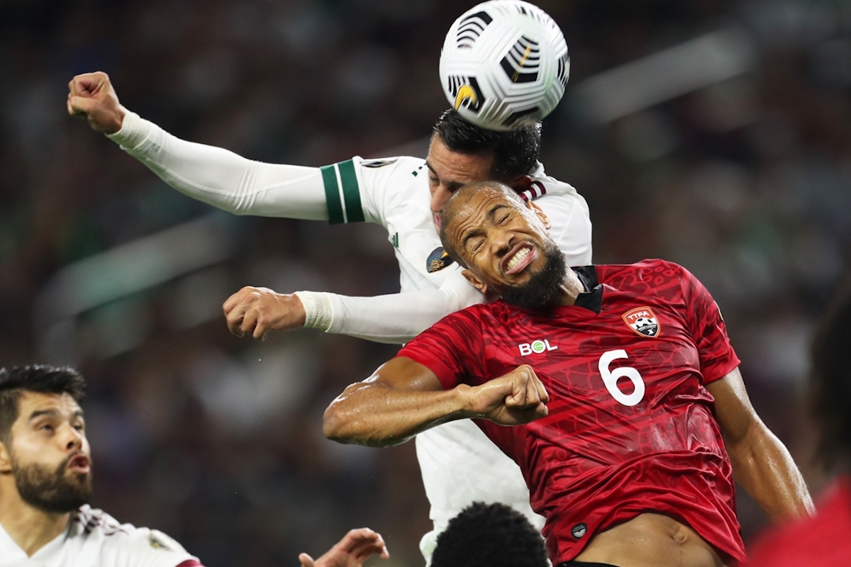 Radanfah Abu Bakr #6 of Trinidad & Tobago and Rogelio Funes Mori #11 of Mexico head the ball during the match of CONCACAF Gold Cup Group A between Mexico and Trinidad & Tobago at AT&T Stadium on July 10, 2021 in Arlington, Texas. (Photo by Omar Vega/Getty Images)