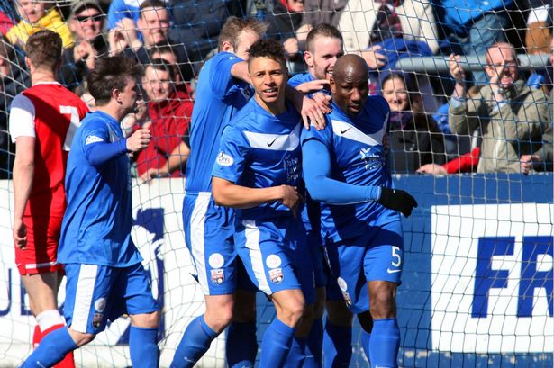 Marvin Andrews celebrating with teammates after scoring a goal