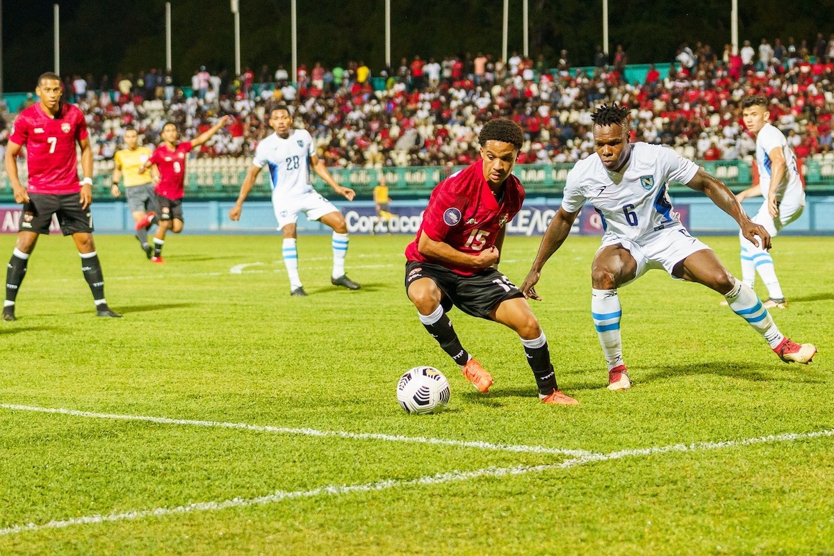 Trinidad and Tobago's Kaïlé Auvray (#15) attempts to collect the ball while under pressure from Nicaragua's Luis Copete (#6) during a Concacaf Nations League Group C match at Dwight Yorke Stadium, Bacolet, Tobago on Monday, March 27th 2023.