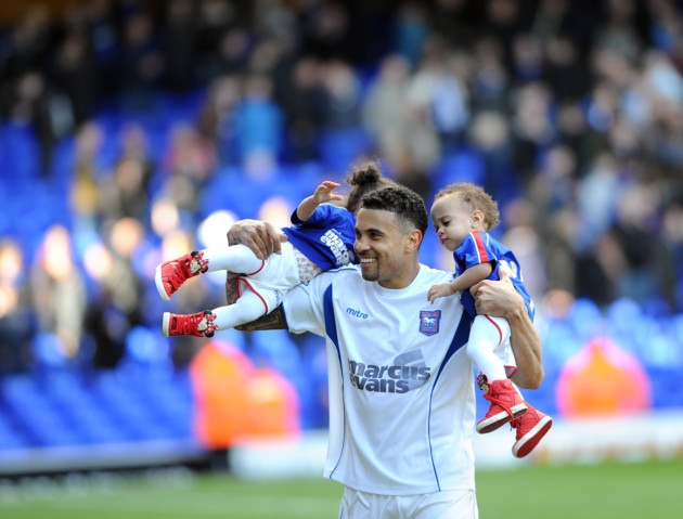 Carlos Edwards does a lap of honour with his young twins, who were born prematurely during his time at Ipswich Town