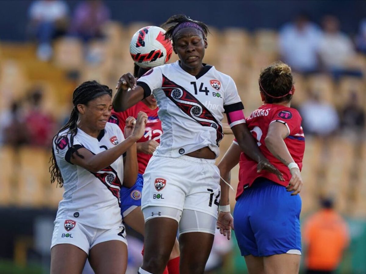 Trinidad and Tobago's Karyn Forbes, centre, and Costa Rica's Carolina Vanegas, right, jump to head a ball during a CONCACAF Women's Championship match in Monterrey, Mexico, on Friday, July 8th 2022 (AP Photo)