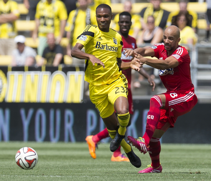 Jun 29, 2014; Columbus, OH, USA; FC Dallas midfielder Peter Luccin (8) battles for the ball wtih Columbus Crew defender Kevan George (23) at Crew Stadium. The game ended in a 0-0 tie. Credit: Greg Bartram-USA TODAY Sports